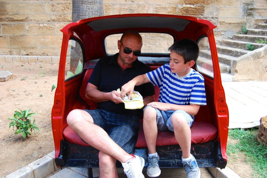 Stefano and Luca sample local pastries in the back end of a Fiat 500-turned street art.